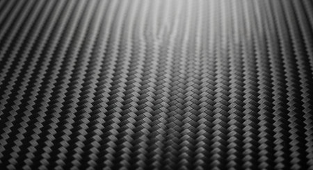 Dark gray carbon fiber material with a finely woven diagonal pattern, showcasing its strong and lightweight texture. ideal for high tech and industrial design concepts.の素材