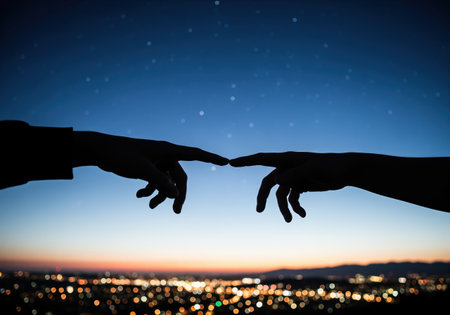 Silhouetted hands reaching out, fingers almost touching, against a vibrant twilight sky with faint stars and sparkling city lights below. symbolizes connection and inspiration.の素材