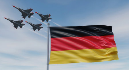 Vibrant german flag with black, red, and gold stripes waving on a flagpole. four military fighter jets fly in a tight formation across a clear blue sky, symbolizing national strength and defense.の素材