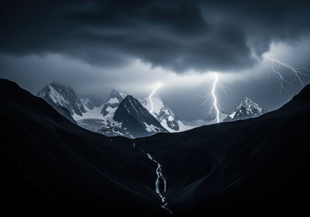 Powerful lightning strikes illuminate snow capped mountain peaks under heavy, dark storm clouds. a dark valley with a winding stream flows in the foreground, emphasizing the dramatic natural power.の素材