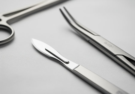 Sharp surgical scalpel and metallic forceps, essential medical instruments, precisely arranged on a clean, sterile white background, highlighting precision and healthcare.の素材