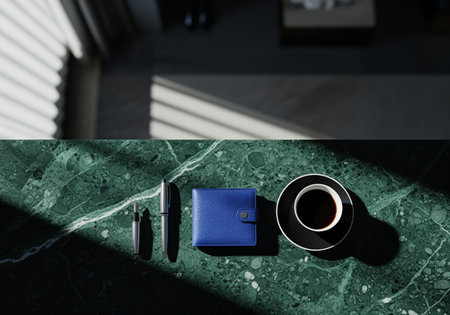 Overhead view of a blue leather wallet, coffee cup, and two pens arranged on a vibrant green marble surface. strong shadows suggest morning light, ideal for luxury lifestyle and business concepts.の素材