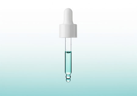 A clear glass dropper filled with a pale turquoise blue essence, perfect for showcasing skincare serums, cosmetic oils, or medical solutions.の素材