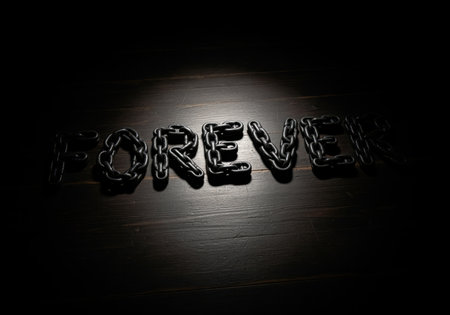 The word FOREVER is dramatically spelled out using heavy, dark metal chains, illuminated by a focused spotlight. this image conveys themes of strength, commitment, and eternity.の素材
