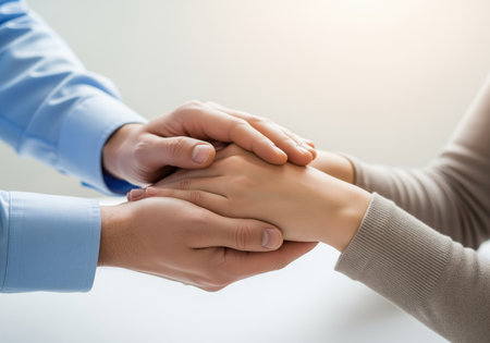 Man gently holding a woman hands in a gesture of comfort, care, and emotional support. this close up symbolizes empathy, connection, trust, and professional counseling or therapyの素材