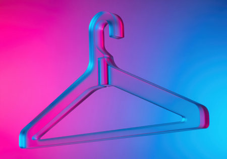 Transparent plastic clothes hanger dramatically lit by vibrant neon pink and blue duotone lights. conceptual image for fashion, retail, shopping, and modern design themes.の素材