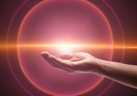 Human hand held palm up, centered on a bright, glowing light source. features a strong horizontal lens flare and concentric magenta rings on a dark, conceptual background. represents power, spirituality, and energy transfer.の素材