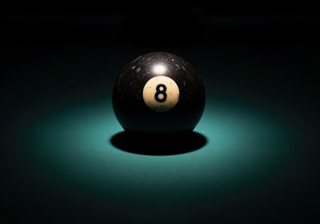 Vintage black 8 ball resting on dark green pool table felt, dramatically illuminated by a spotlight. represents fate, luck, and gaming.の素材
