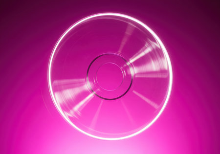 Translucent polycarbonate disc, resembling a blank CD or DVD, suspended mid air against a deep, vibrant magenta gradient backdrop. conceptual image representing data, technology, storage, and digital media.の素材