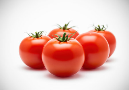 Five vibrant red ripe tomatoes with fresh green stems, arranged closely together. studio shot isolated on a clean white background, symbolizing healthy eating and freshness.の素材