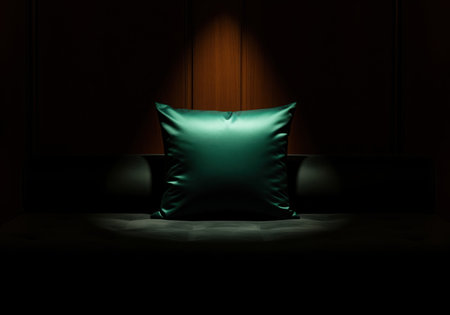 A luxurious square cushion made of shimmering dark green silk or satin fabric rests on a dark surface. the dramatic spotlight emphasizes the rich texture and opulent mood, perfect for luxury interior design concepts.の素材
