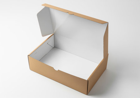 Empty brown corrugated cardboard box fully opened, revealing a clean white interior, isolated on a light studio background. ideal for shipping, delivery, or product packaging mockups.の素材