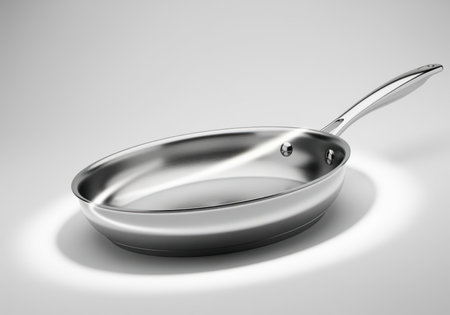 Polished stainless steel frying pan, a sleek kitchen utensil for cooking, presented in a high key studio product shot. durable and professional equipment.の素材