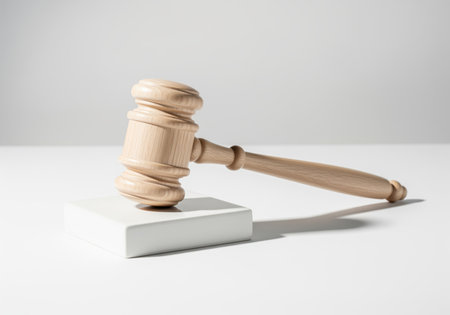 Wooden gavel and sound block displayed in a clean, minimalist studio environment. represents law, justice, court, authority, judgment, and final decision.の素材