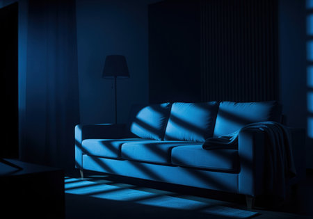 Modern sofa in a dark, moody living room interior illuminated by cool blue light. dramatic geometric shadows fall across the couch and floor, creating a mysterious and cinematic atmosphere at night.の素材