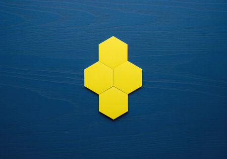 Four vibrant yellow hexagonal shapes are tightly clustered together, creating a modular vertical design against a contrasting deep blue surface. this abstract pattern is ideal for concepts related to structure, connection, and technology.の素材