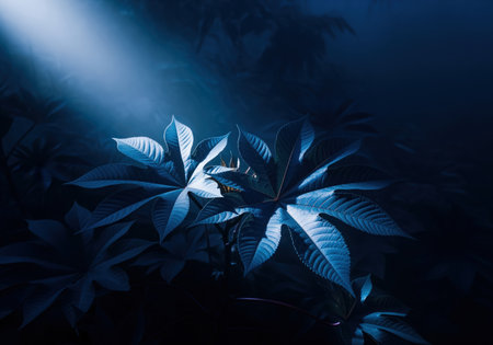 Deep indigo blue castor oil plant leaves emerge from heavy mist, illuminated by a dramatic ray of light. mysterious and intense botanical scene with dark, moody atmosphere.の素材