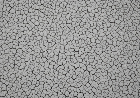 Gray cracked clay texture, ultra sharp and minimalist, filling the entire frame. represents drought, dryness, global warming, and environmental issues.の素材
