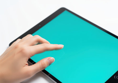Woman hand interacting with a modern digital tablet featuring a blank teal screen, perfect for displaying app interfaces, websites, or creative content. technology and communication concept.の素材