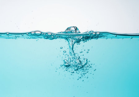 A vibrant aqua water surface with energetic splashes and numerous air bubbles creating a refreshing and dynamic liquid motion. ideal for themes of purity, hydration, and fluidity.の素材