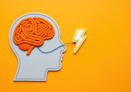 A conceptual flat lay visualizes mind activation and creative thinking. a human head profile with an orange brain connects to a lightning bolt, symbolizing ideas and energy.の素材