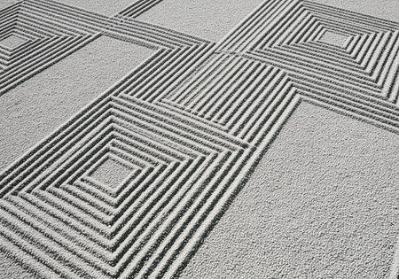 A top down view of pristine light grey gravel intricately raked to form elegant, sharp, angular patterns, creating a serene and meditative texture.の素材