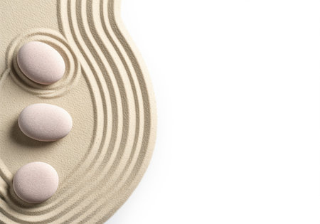 A serene and minimalist zen garden featuring three smooth, light colored stones arranged on finely raked beige sand, creating a calming atmosphere for meditation or relaxation.の素材