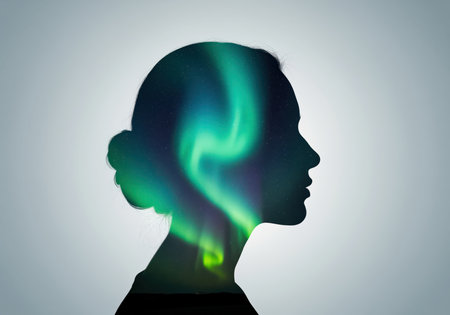 A creative double exposure combines a woman head profile with the vibrant, swirling lights of the aurora borealis, suggesting imagination or a connection to nature.の素材