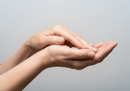 A close up shot of mature hands, one resting gently on the other with palms open. this image conveys a sense of care, offering, or receiving, suitable for themes of compassion, giving, or human connection.の素材