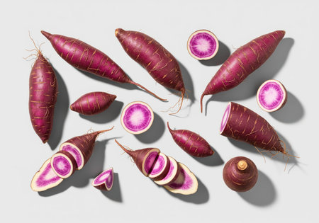 A collection of raw purple yams, some whole and some precisely sliced, showcasing their striking purple and white flesh. ideal for healthy eating, cooking, or agricultural themes.の素材
