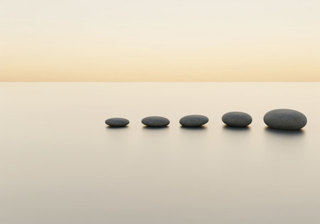A minimalist composition features five smooth, dark grey, oval stepping stones arranged in a progression on a serene, reflective surface, evoking balance and forward movement.の素材