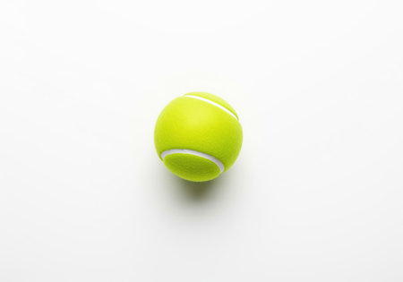 A single, vibrant yellow green tennis ball with white seams, perfect for illustrating sports, games, and active lifestyles. it can be used for various athletic themes.の素材