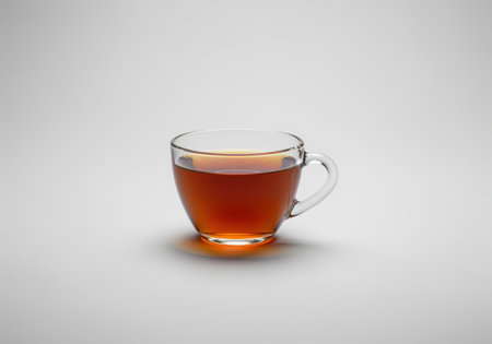 A transparent glass teacup holds a rich, dark amber tea, showcasing its inviting color and clarity. perfect for beverage, lifestyle, or health related content.の素材