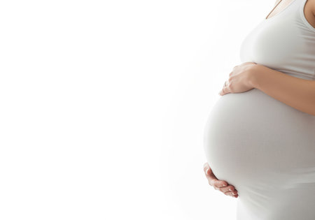 A tender close up of a pregnant woman belly, with her hands gently placed, conveying warmth, anticipation, and the miracle of new life. ideal for health, family, and maternity themes.の素材