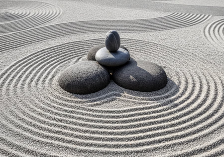 Japanese Zen garden with raked gravel patterns, featuring a balanced stack of dark smooth stones. Symbolizes tranquility, meditation, and harmony.の素材