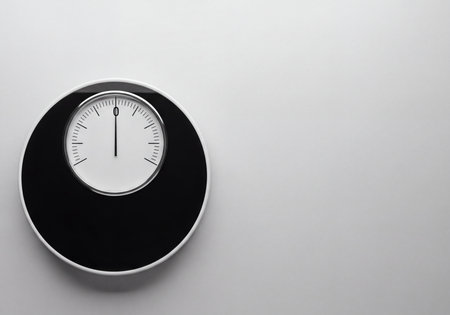 Sleek, minimalist black and white circular scale with a needle pointing to zero against a clean, light background. Ideal for concepts of weight loss, reset, starting point, and measurement.の素材