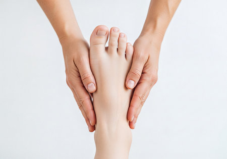Gentle female hands massaging a woman's sole and toes, highlighting foot care, health, relaxation, and spa treatments. Focus on wellness, comfort, and beauty.の素材