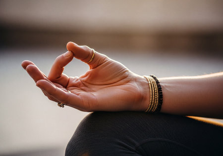 A close up of a woman hand performing chin mudra during a yoga or meditation session, featuring rings and bracelets on her wrist.の素材