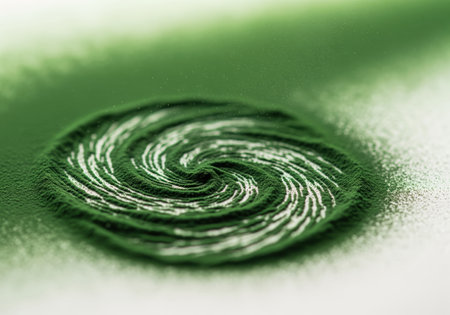 A close up view of vibrant emerald green superfood powder, likely spirulina or chlorella, meticulously arranged into a dynamic, swirling vortex pattern. this abstract composition is ideal for health, wellness, and nutrition content.の素材