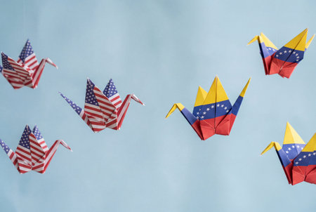 Paper cranes featuring the national flags of the united states and venezuela fly towards one another against a soft blue background to symbolize diplomatic dialogue and international relations.の素材