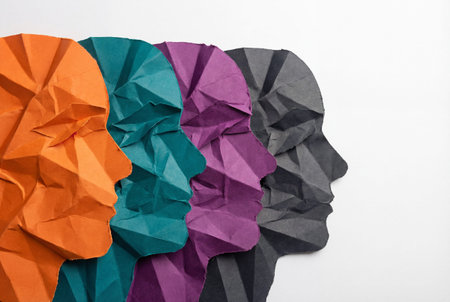 A closeup view of colorful paper sculptures representing diverse human faces created with folded paper techniques, illustrating creativity and artistry in designの素材