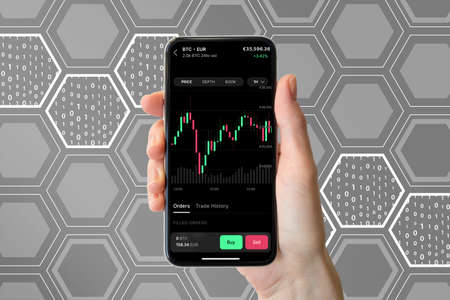 Frankfurt, Germany - 03.01.2022: Coinbase Pro app displayed on modern smart phone. Hand holding...