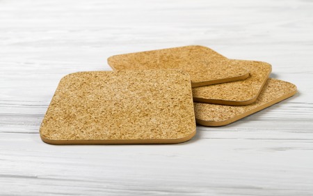 Cup coasters set on white wooden backgroundの写真素材