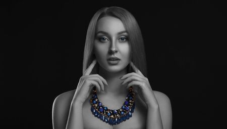 Portrait of beautiful girl with straight shiny hair wearing blue necklace - Beauty and fashion portraitの写真素材