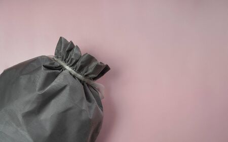 Top view of textile gray bag on pink color background with copy spaceの写真素材