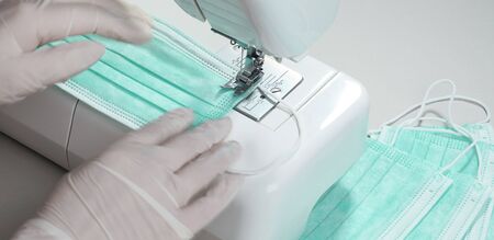 Close up Manufacturing process of medical protective masks on sewing machineの写真素材