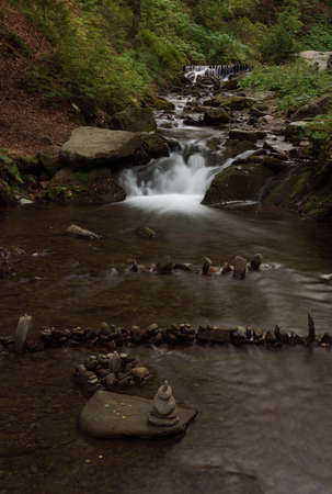 Balanced rocks in river in the forest