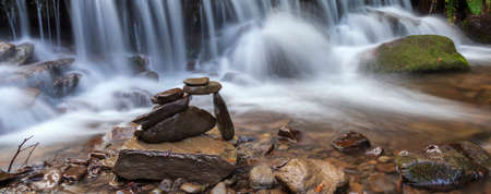Stacked rocks on mountain river sideの写真素材