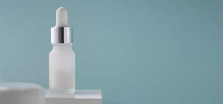 White Pipet bottle on blue background with copy spaceの写真素材