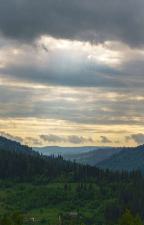 Sun light beams through the clouds on Carpathian mountains chain in Ukraineの写真素材